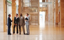 Group of successful business colleagues standing at a hallway