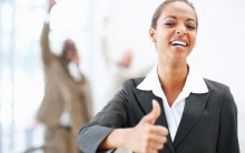 Portrait of a pretty African American business woman showing a thumbs up sign